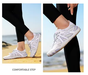 Detail showing white and purple outdoor barefoot water shoes with quick-lace system