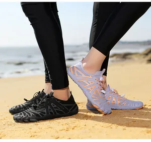 Outdoor water shoes on beach showing mesh upper and non-slip rubber outsoles