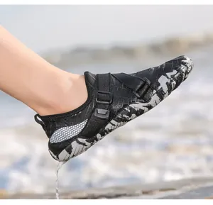 Detail of black quick-dry water shoes with dual straps and non-slip camouflage rubber sole