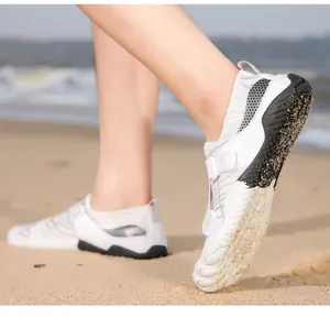 Detailed close-up of quick-dry water shoes with anti-slip rubber sole on sandy beach