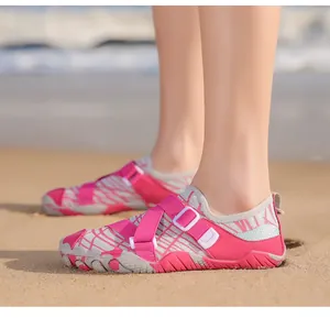 Close-up of pink and grey water shoes with mesh fabric and adjustable velcro straps