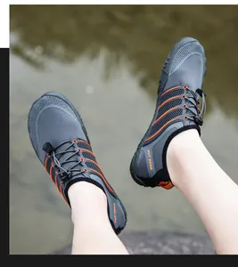 Close-up of grey and orange quick-lace hiking water shoes with honeycomb mesh upper