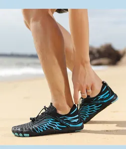 Outdoor barefoot water shoes with quick-lace system and blue patterns on beach