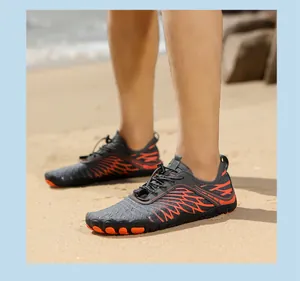 Detail of outdoor water shoes with quick-lace system and non-slip rubber sole on sand