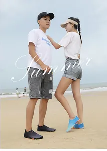 Outdoor couple water shoes featuring breathable fabric and non-slip soles on a beach setting
