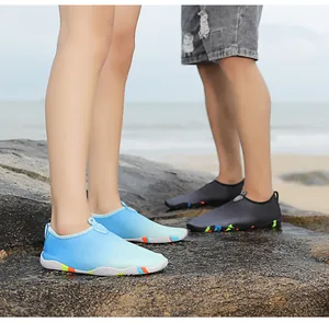 Outdoor water shoes with honeycomb mesh and anti-slip rubber soles on ocean rocks