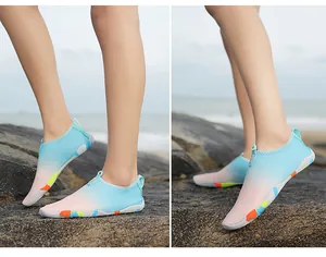 Outdoor water shoes with breathable gradient mesh and non-slip rubber soles on rocks
