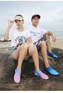 Outdoor water shoes for hiking and swimming shown on a beach in purple and blue