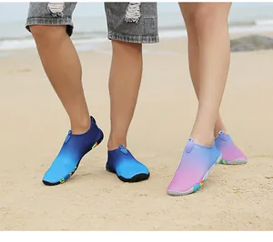 Detail of quick-dry water shoes on a sandy beach featuring non-slip rubber outsoles