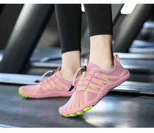 Action shot of pink and green quick-dry barefoot water shoes on a treadmill