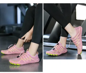 Close-up of pink and green quick-dry water shoes with toggle lacing on a treadmill