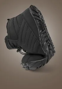 Detailed view of flexible anti-slip rubber sole on black high-top warm winter snow boots