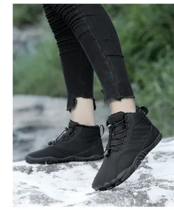 Detail of black high-top snow boots featuring plush lining and elastic drawstring laces