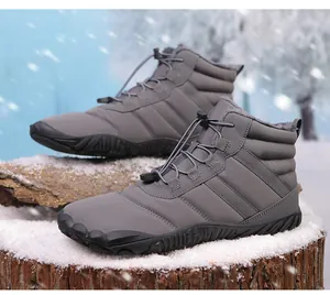 Detail of high-top winter boots with quilted fabric and thick fleece lining on snow