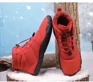 Close-up of red waterproof snow boots with plush faux fur lining and anti-slip rubber soles