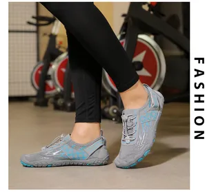 Close-up of gray quick-dry water shoes with elastic drawstring laces in a gym setting