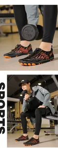 Detail view of quick-dry water shoes with non-slip rubber soles and sporty orange accents