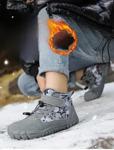 Detailed view of warm children's winter boots with star pattern and plush lining in snow