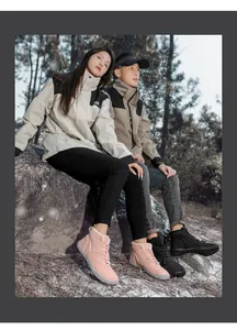 Pink and black thermal snow boots with drawstring laces shown in outdoor forest scenery