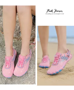 Detail of pink quick-dry water shoes featuring breathable mesh and fast lacing system