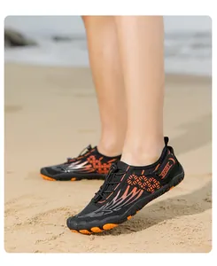 Detail of outdoor wading shoes with black mesh, orange flame accents, and anti-slip sole