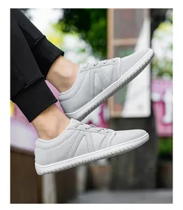 Vue portée de chaussures de marche en mesh gris clair respirant et semelles blanches