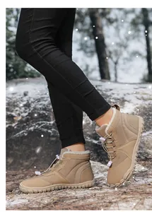 Close-up of khaki winter snow boots with white faux shearling lining and drawstring laces