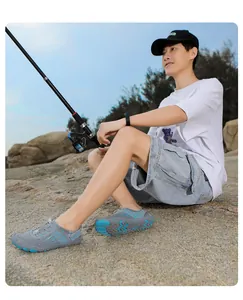 Close-up of quick-dry water shoes with non-slip rubber soles on coastal rocks