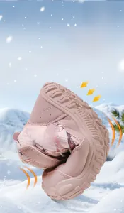 Detail showing the ultra-flexible rubber sole of pink kids winter boots on a snowy background