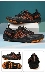 Detail view of black and orange water shoes with quick-lace system and anti-slip rubber sole