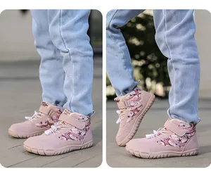 Detailed view of pink winter boots for kids featuring star prints and fleece lining