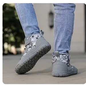 Detail showing non-slip thick rubber sole and grey star pattern of kids winter boots