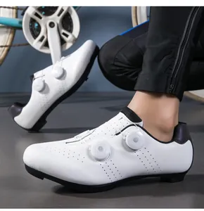 Close-up of white cycling shoes featuring double rotary dials and breathable laser perforations