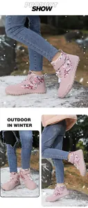 Detail of pink winter boots with warm plush lining and purple star patterns for kids