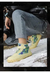 Close-up of kids winter snow boots with star print and warm fleece lining in the snow