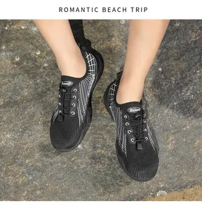 Top view of breathable mesh water shoes with quick-lace system on a rocky beach