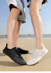 Breathable quick-dry water shoes with non-slip soles on a sandy beach scene