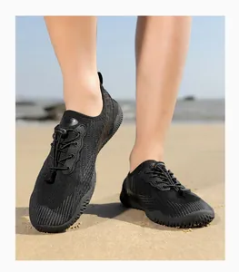 Outdoor water shoes with breathable mesh and elastic quick-lace system on beach