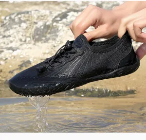 Detail of black water shoes featuring breathable mesh and quick-lace system over water