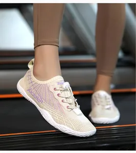 Detail view of breathable mesh gym shoes with purple patterns and toggle lacing system
