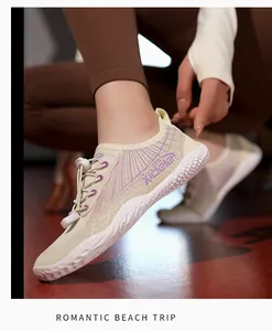 Detail of breathable mesh upper with purple pattern and elastic toggle closure on water shoes