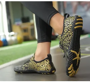 Close-up of leopard print barefoot water shoes with durable yellow anti-slip rubber soles