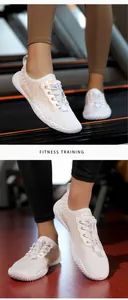 Detail of white mesh fitness shoes with quick-lace system and anti-slip sole on treadmill