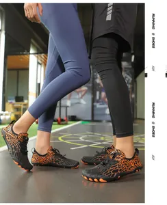 Detail of five-toe hiking shoes featuring orange leopard pattern and quick-lace system