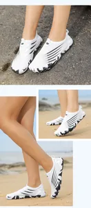 Detail of breathable mesh aqua shoes with non-slip marble sole on rocky beach