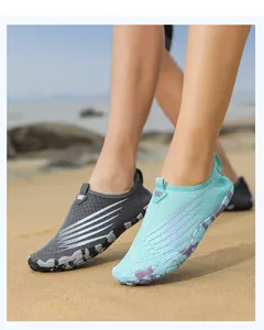 Detailed view of quick-dry barefoot shoes with non-slip soles on a sandy beach