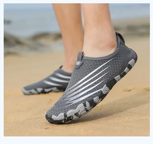 Macro shot of breathable gray mesh fabric and non-slip rubber sole for outdoor water shoes