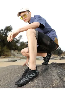 Detail of quick-dry water shoes with breathable mesh and adjustable bungee cord on beach