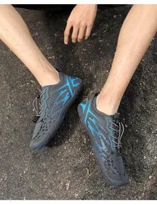 Outdoor view of breathable quick-dry water shoes with gray mesh and blue details on asphalt