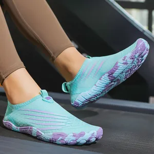 Blue and purple outdoor water shoes for hiking and fitness shown on a treadmill